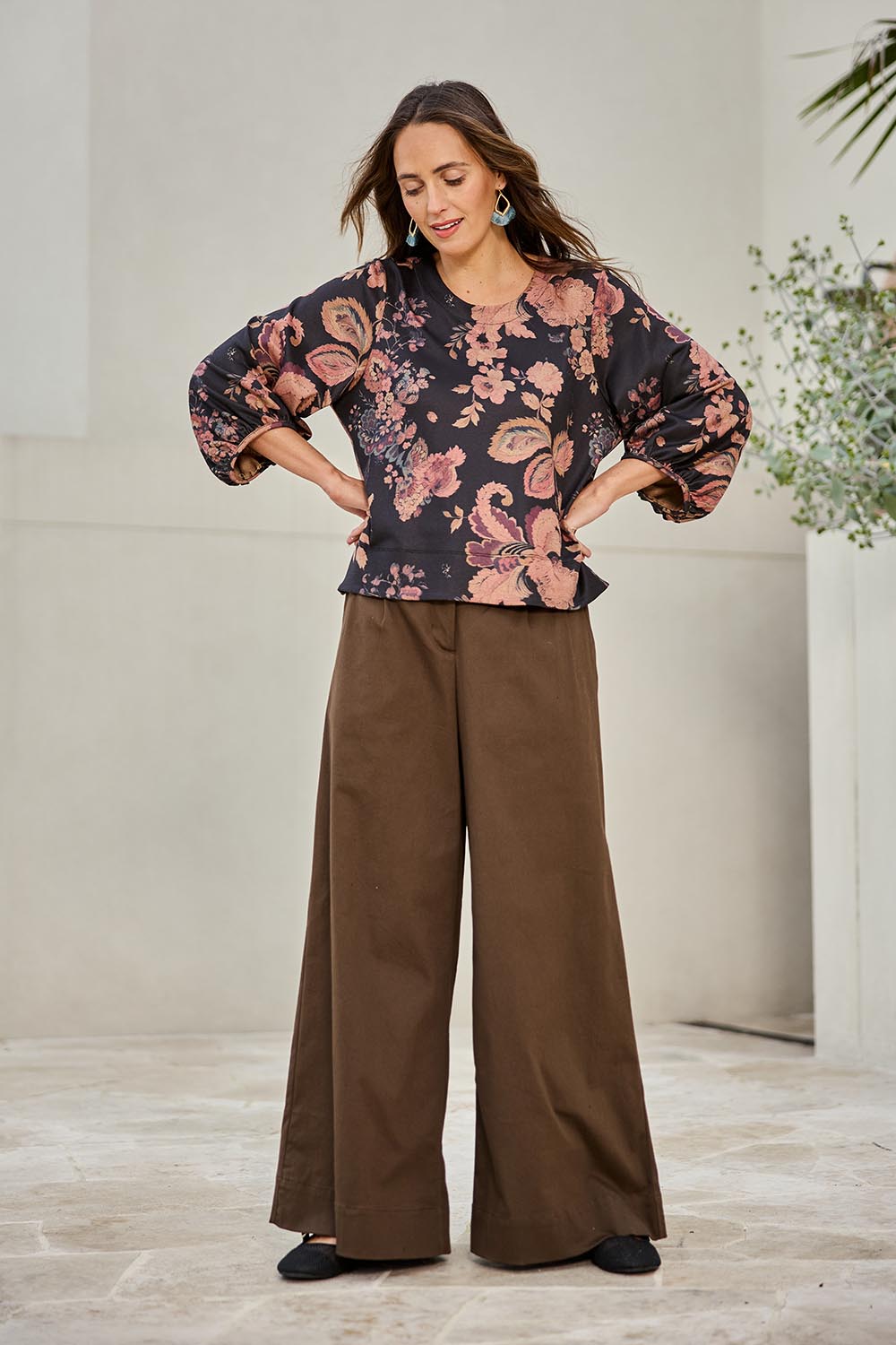 Model Tegand wearing size 10 of the Need You In My Life Pants - Cocoa in colour Cocoa, from the front