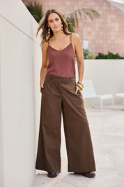 Model Tegand wearing size 10 of the Need You In My Life Pants - Cocoa in colour Cocoa, from the front