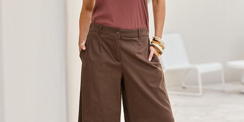 Model Tegand wearing size 10 of the Need You In My Life Pants - Cocoa in colour Cocoa, from the front