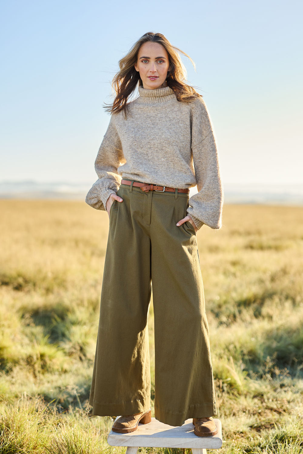 Model Cara wearing size 10 of the Need You In My Life Pants in colour Moss (Green), from the front, showing the whole outfit