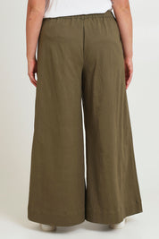 Model Chanel wearing size 16 of the Need You In My Life Pants in colour Moss (Green), from the back