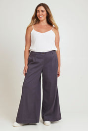 Model Chanel wearing size 18 of the Need You In My Life Pants in colour Steel (Grey), from the front, showing the whole outfit