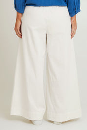 Model Laura wearing size 14 of the Need You In My Life Pants in colour White (White), from the back