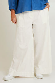 Model Laura wearing size 14 of the Need You In My Life Pants in colour White (White), from the front, cropped image