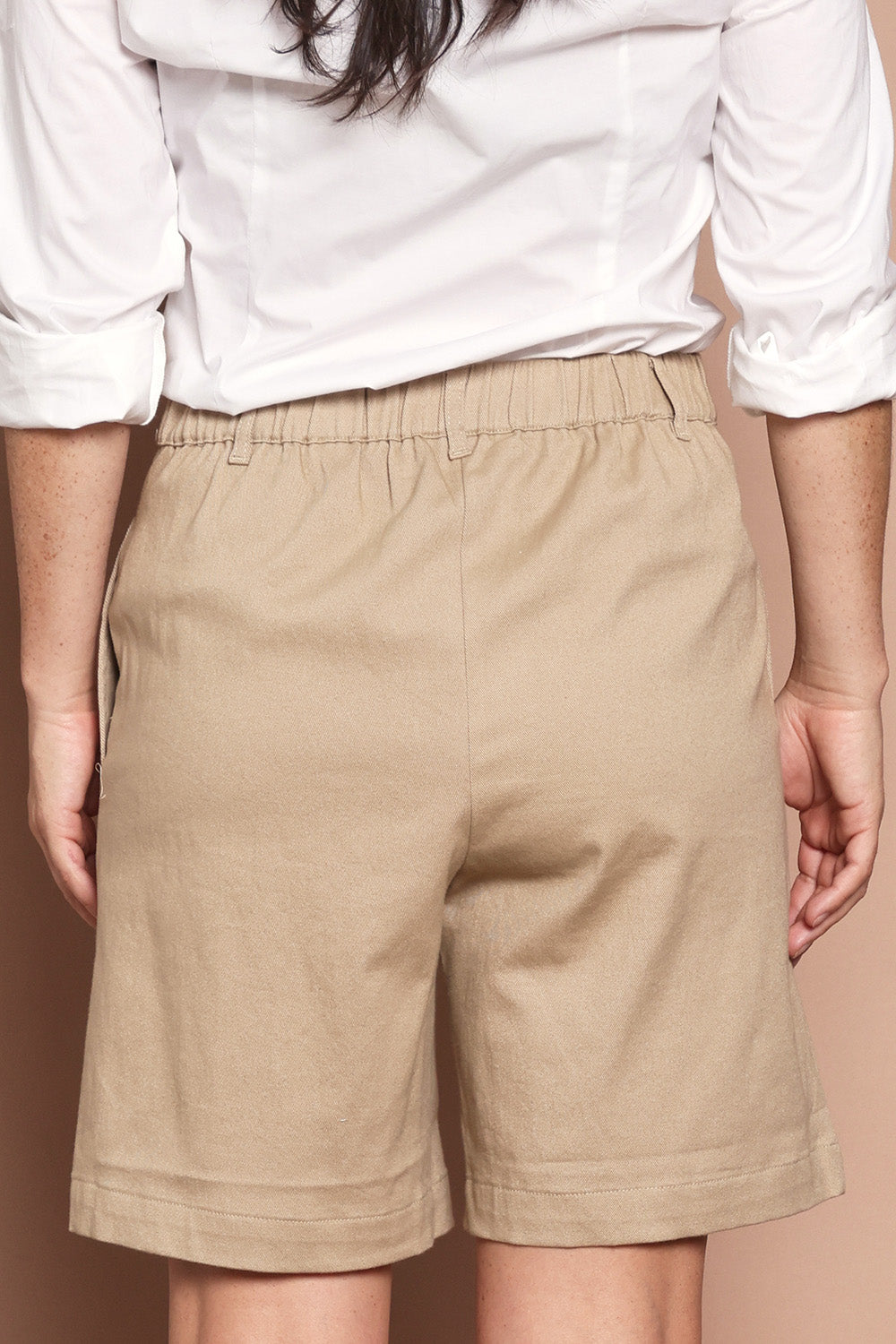 Model Katie wearing size 10 of the Need You In My Life Shorts in colour Sand, from the back