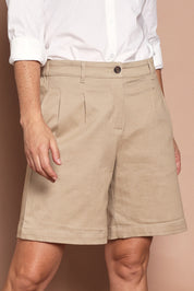 Model Katie wearing size 10 of the Need You In My Life Shorts in colour Sand, from the front, cropped image