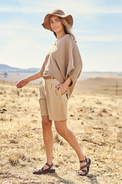 Model Tegan wearing size 10 of the Need You In My Life Shorts in colour Sand, from the front, showing the whole outfit