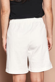 Model Katie wearing size 10 of the Need You In My Life Shorts in colour White (White), from the back