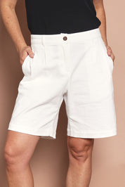 Model Katie wearing size 10 of the Need You In My Life Shorts in colour White (White), from the front, cropped image