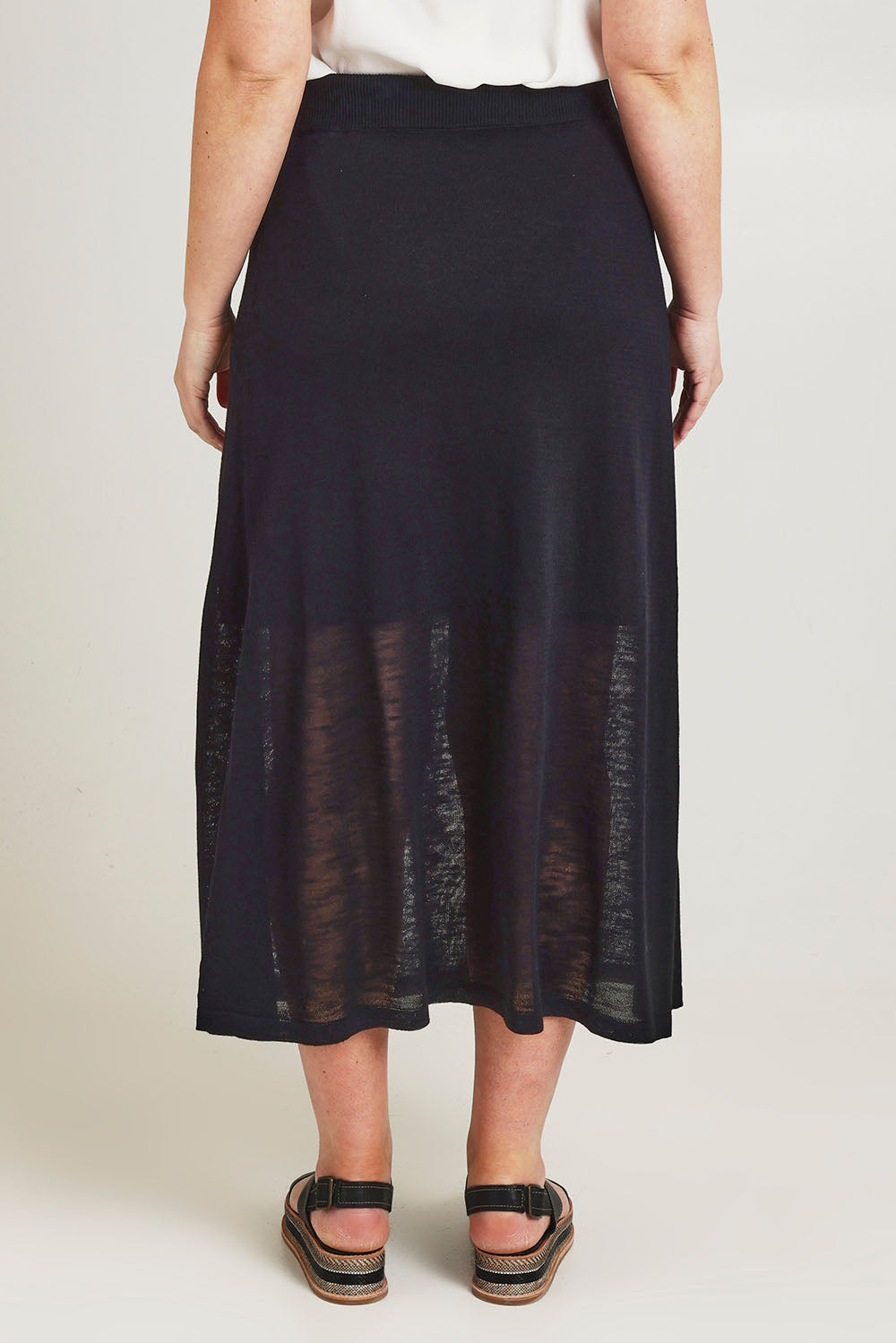 Model Jane wearing size L of the Go To Knit Skirt in colour Black (Black), from the back