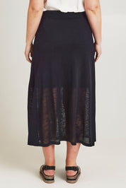 Model Jane wearing size L of the Go To Knit Skirt in colour Black (Black), from the back