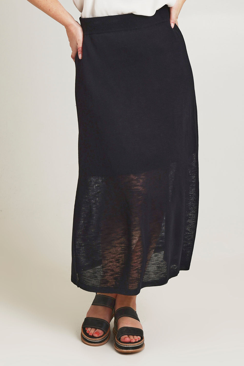 Model Jane wearing size L of the Go To Knit Skirt in colour Black (Black), from the front, cropped image