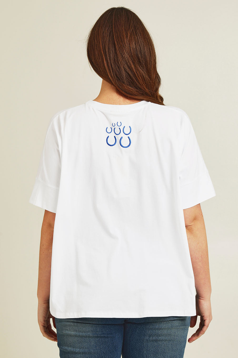 Model Jane wearing size 14 of the Loving Life Embroidered Tee in colour Horses (White), from the back