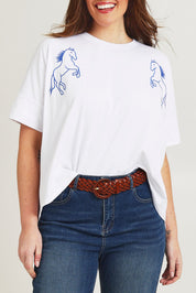 Model Jane wearing size 14 of the Loving Life Embroidered Tee in colour Horses (White), from the front, cropped image