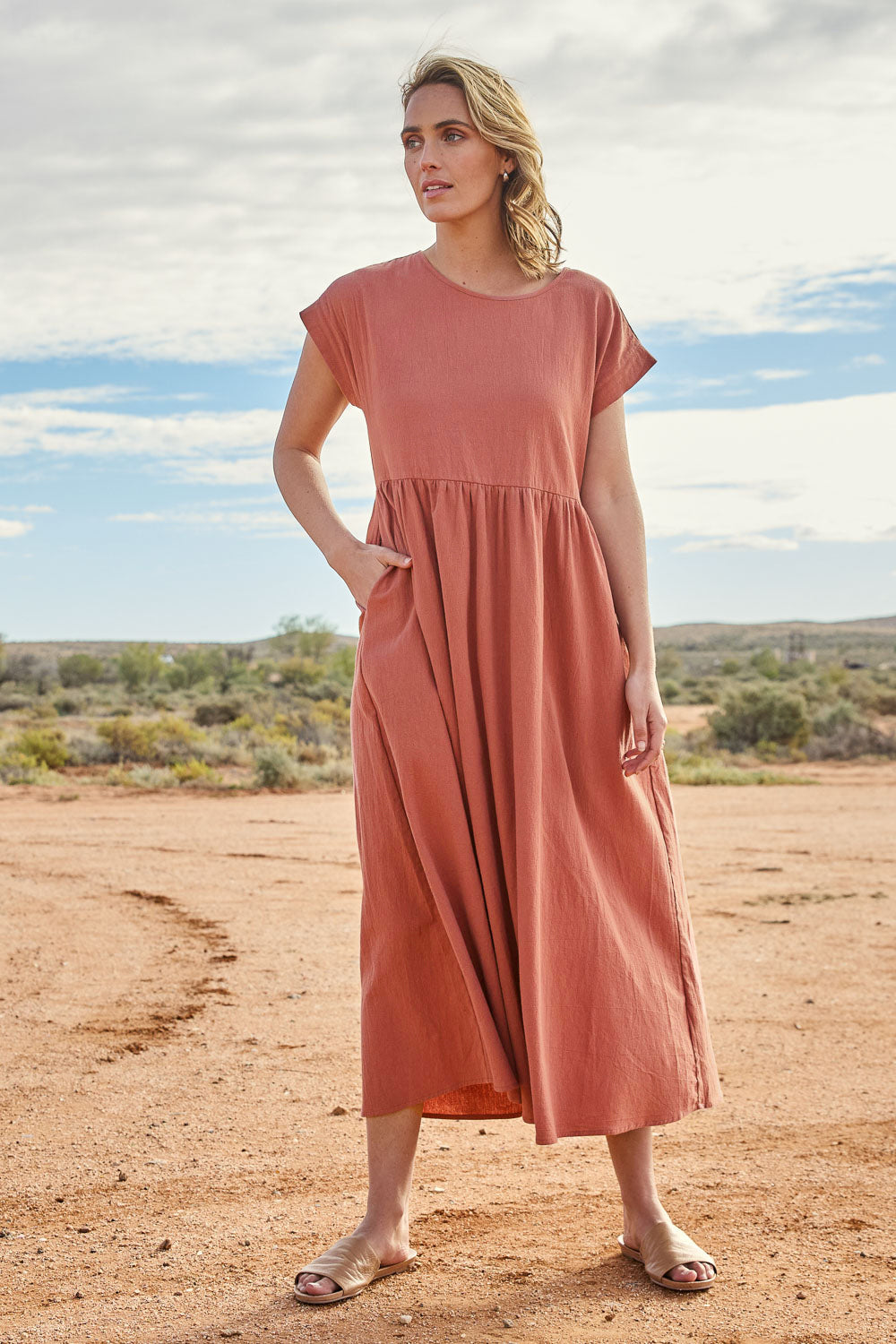 Model Tegan wearing size 10 of the Free Falling Dress in colour Cinnamon, from the front, showing the whole outfit
