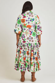 Model Ashleigh wearing size 16 of the Happy Gatherings Short Sleeved Cotton Dress in colour Brightbird, from the back