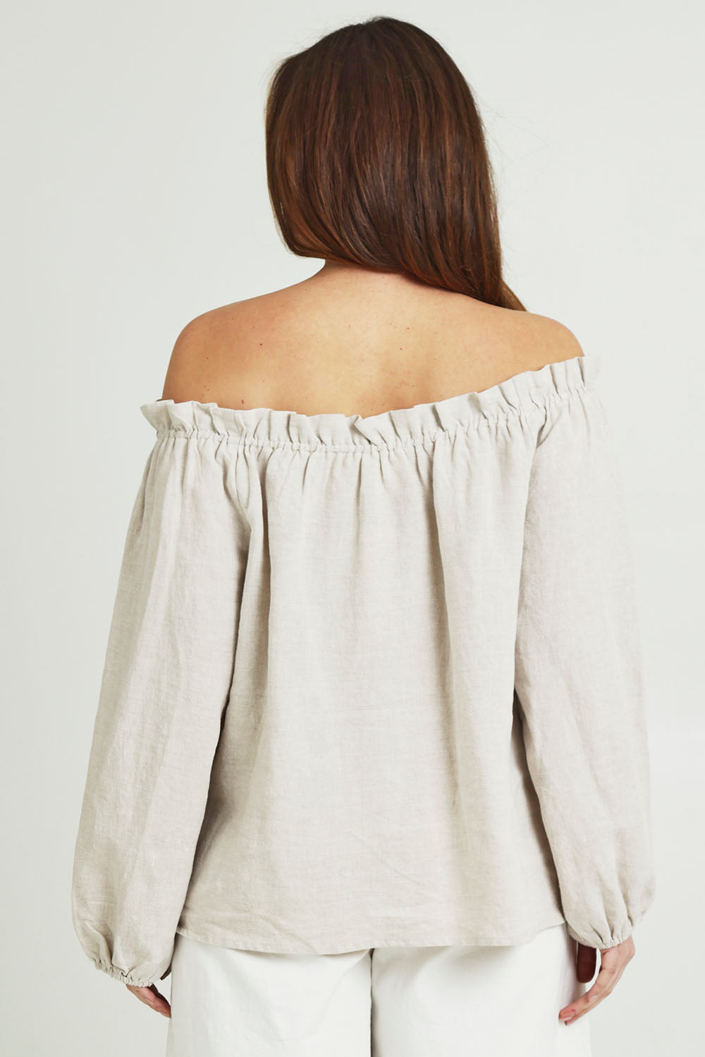Model Jane wearing size 14 of the Shoulder Shimmy Linen Blouse in colour Natural, from the back