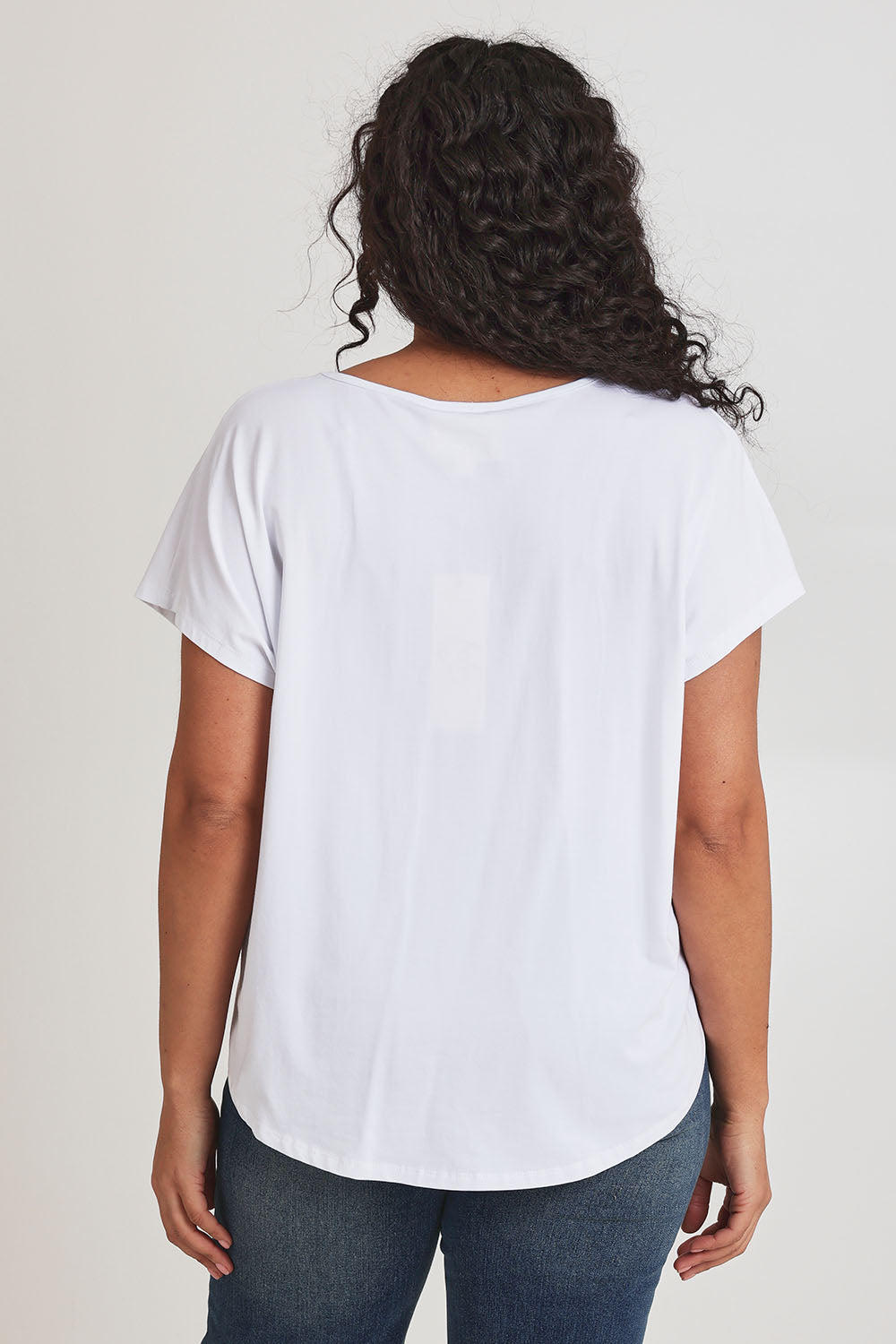 Model Terri-Leigh wearing size 14 of the Little Details Embroidered Tee in colour Whitefish (White), from the back