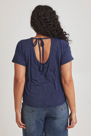 Model Terri-Leigh wearing size 14 of the Saturday Night Low Back Tee in colour Marledenim (Blue), from the back