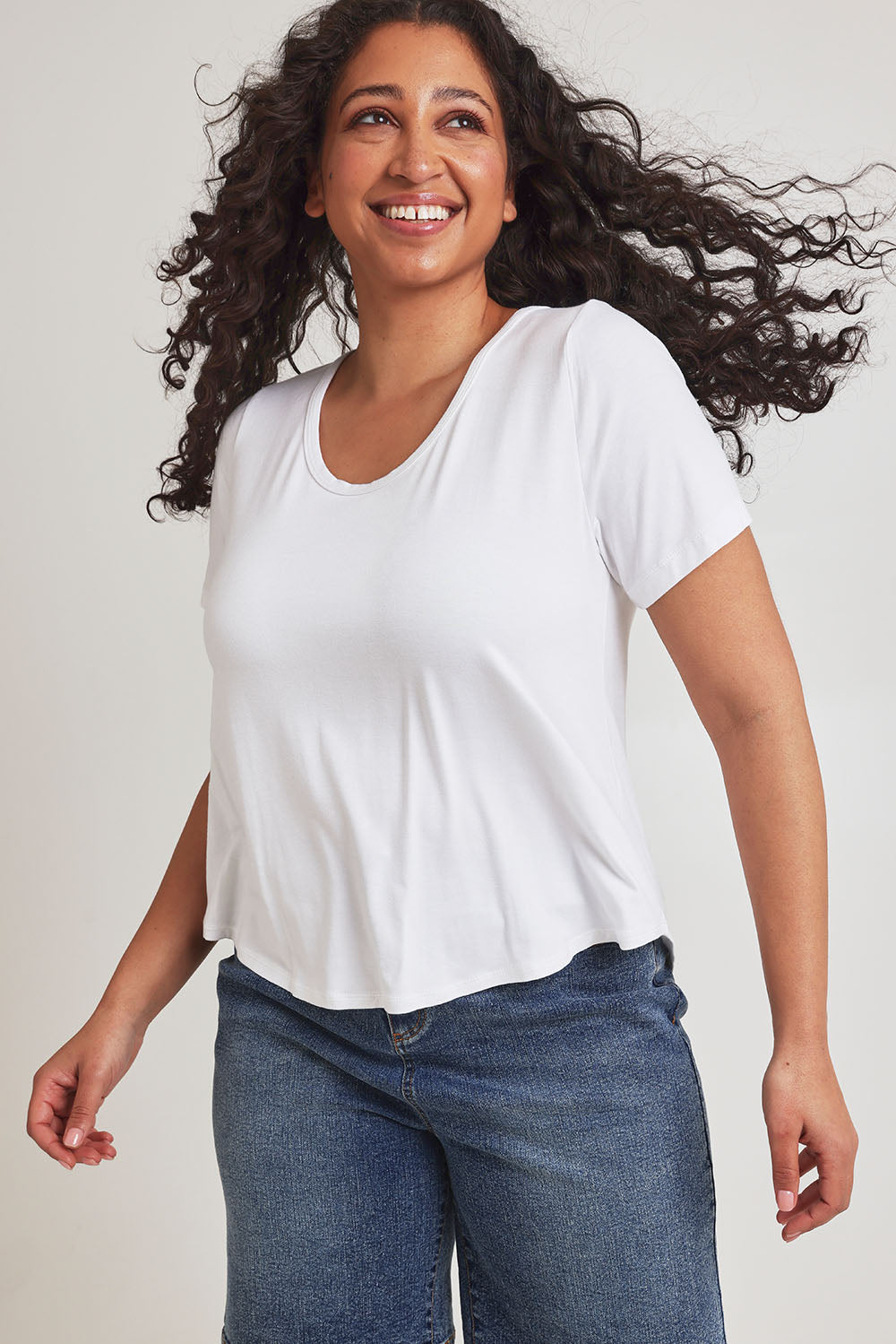 Model Terri-Leigh wearing size 14 of the Saturday Night Low Back Tee in colour White (White), from the front, cropped image