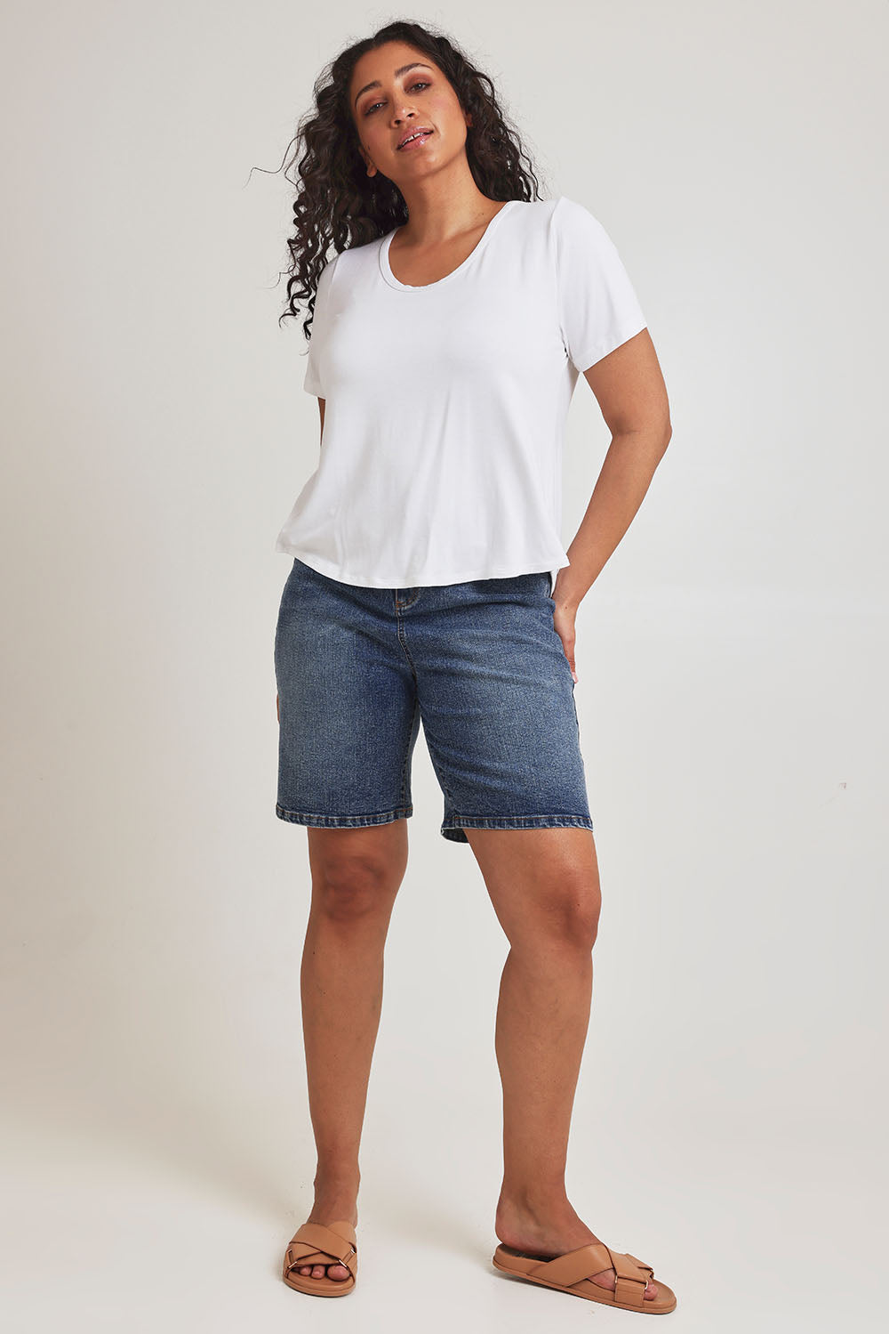 Model Terri-Leigh wearing size 14 of the Saturday Night Low Back Tee in colour White (White), from the front, showing the whole outfit