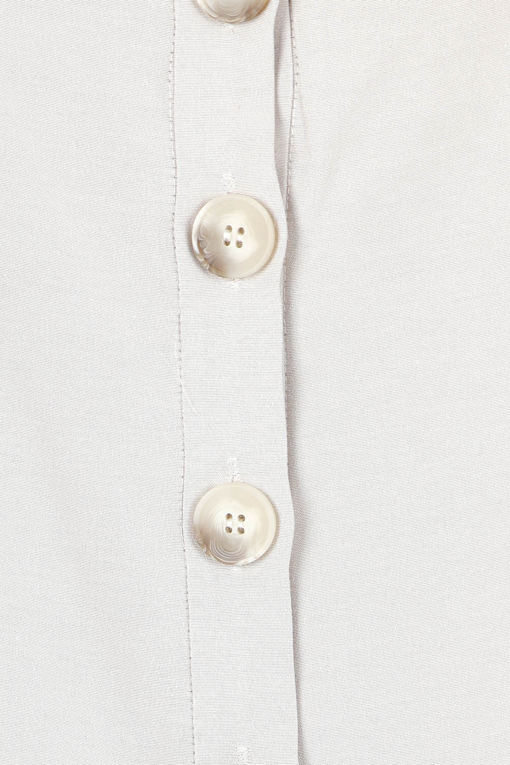 Product shot of the Striding Out Button Through Tank Vest in colour Moet, detail