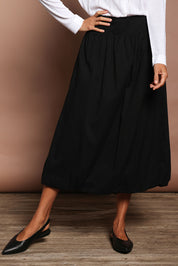 Model Amanda wearing size 10 of the Bubble Delight Cotton Skirt in colour Black (Black), from the front, cropped image