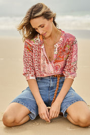 Model Tegan wearing size 10 of the Daily Dose Longline Denim Shorts in colour Denim (Blue), from the front, showing the whole outfit