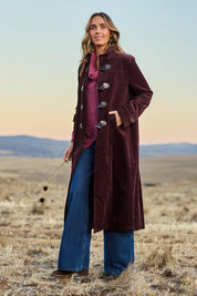Model Tegan wearing size 10 of the Winter Walk Longline Cord Duffle Coat in colour Aubergine (Purple), from the front, showing the whole outfit