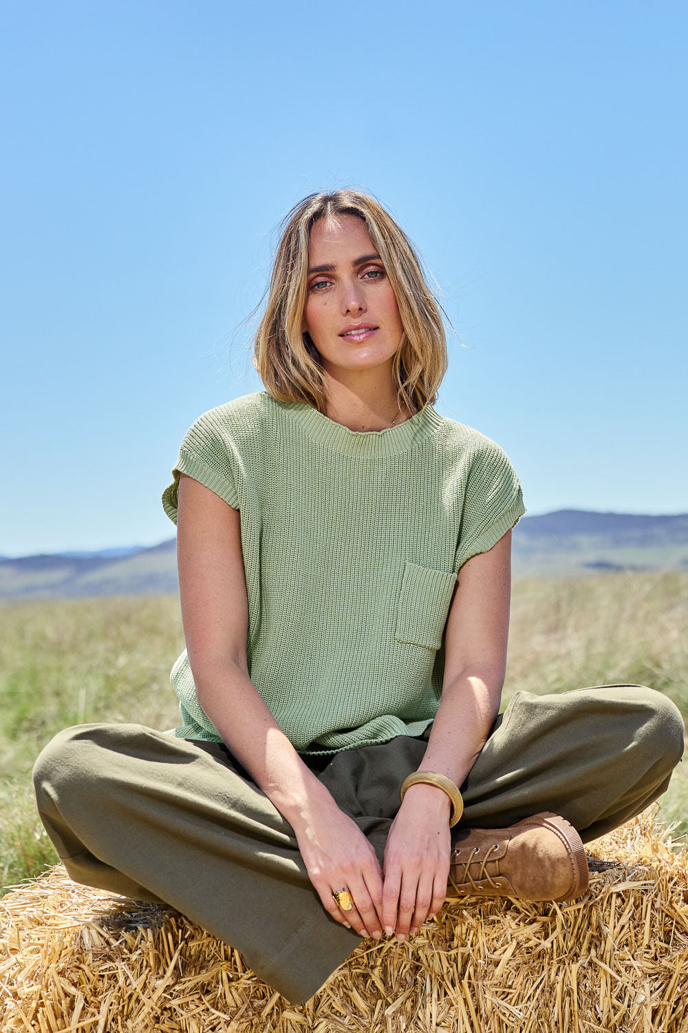 Model Tegan wearing size S of the Cover Me In Cotton Knit Top in colour Fern (Green), from the front, showing the whole outfit