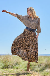 Model Tegan wearing size 10 of the A Delightful Day Tiered Skirt in colour Leopard (Black), from the front, showing the whole outfit