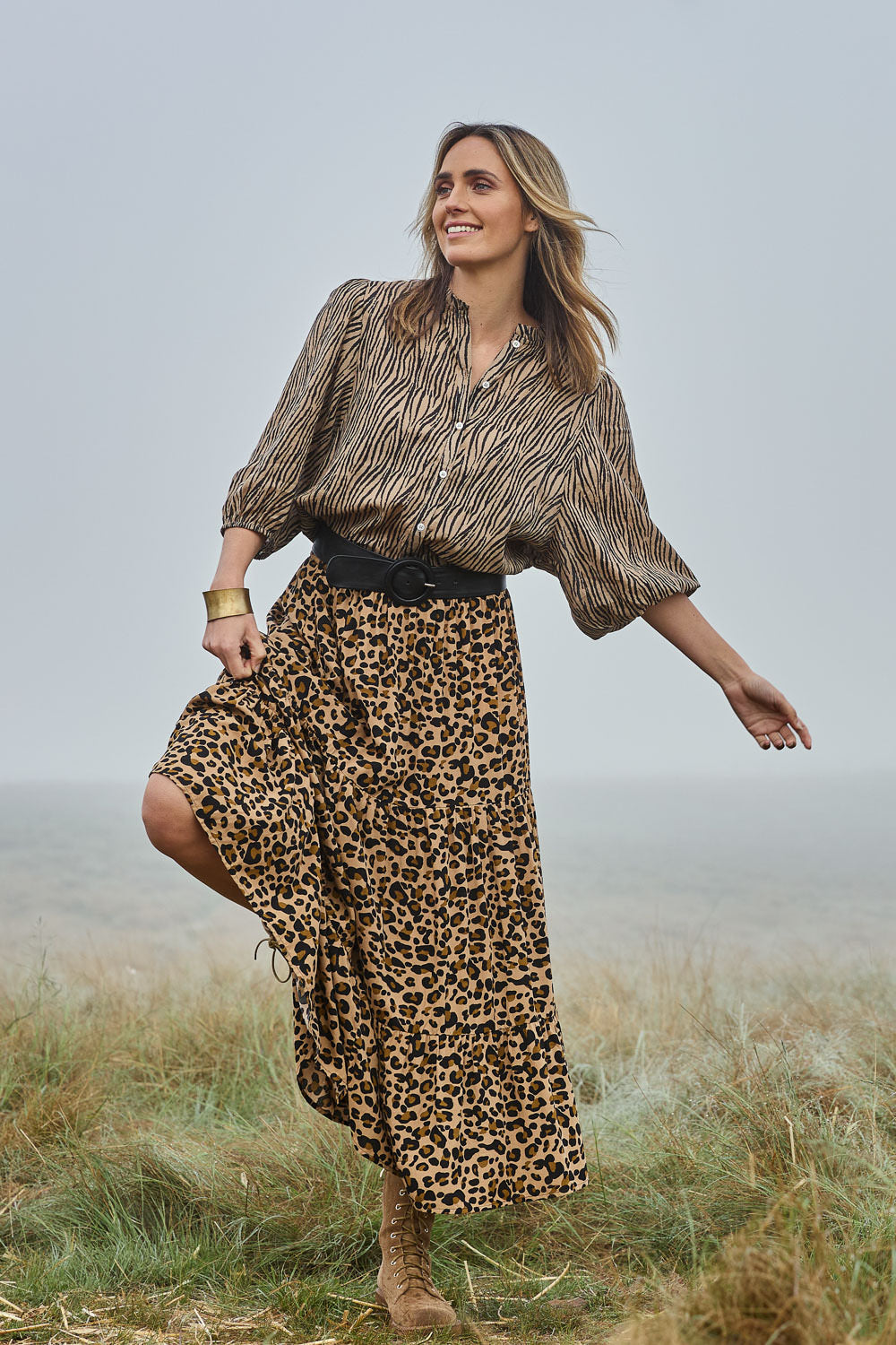 Model Tegan wearing size 10 of the A Delightful Day Tiered Skirt in colour Leopard (Black), from the front, showing the whole outfit