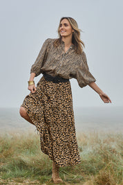 Model Tegan wearing size 10 of the A Delightful Day Tiered Skirt in colour Leopard (Black), from the front, showing the whole outfit