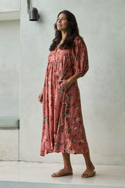 Model Tahnee wearing size 10 of the Full Of Sunshine Midi Dress in colour Clayfleur, from the front, showing the whole outfit