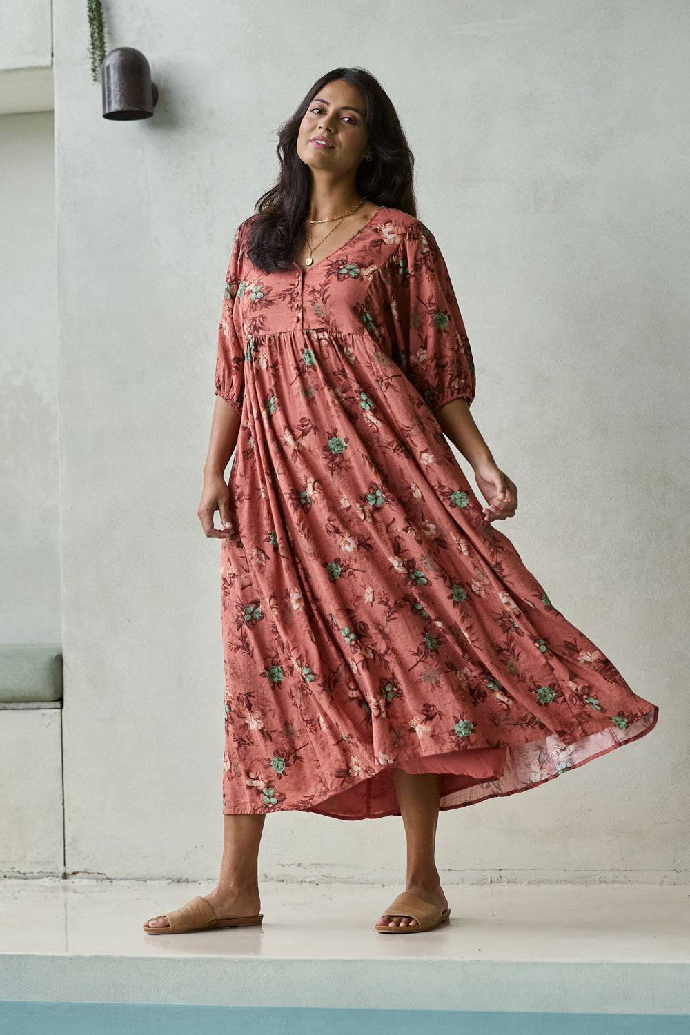 Model Tahnee wearing size 10 of the Full Of Sunshine Midi Dress in colour Clayfleur, from the front, showing the whole outfit
