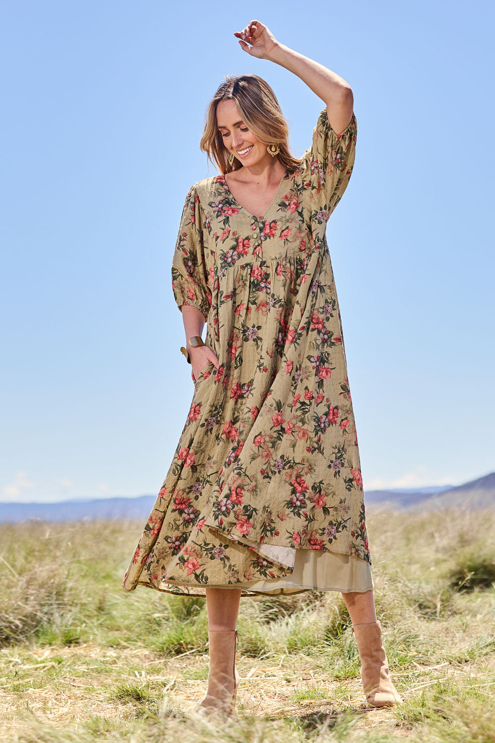 Model Tegan wearing size 10 of the Full Of Sunshine Midi Dress in colour Sagefleur (Green), from the front, showing the whole outfit