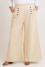 Model Chanel wearing size 16 of the Meet Me At Midnight Wide Leg Ponte Pants in colour Sand, from the front, cropped image