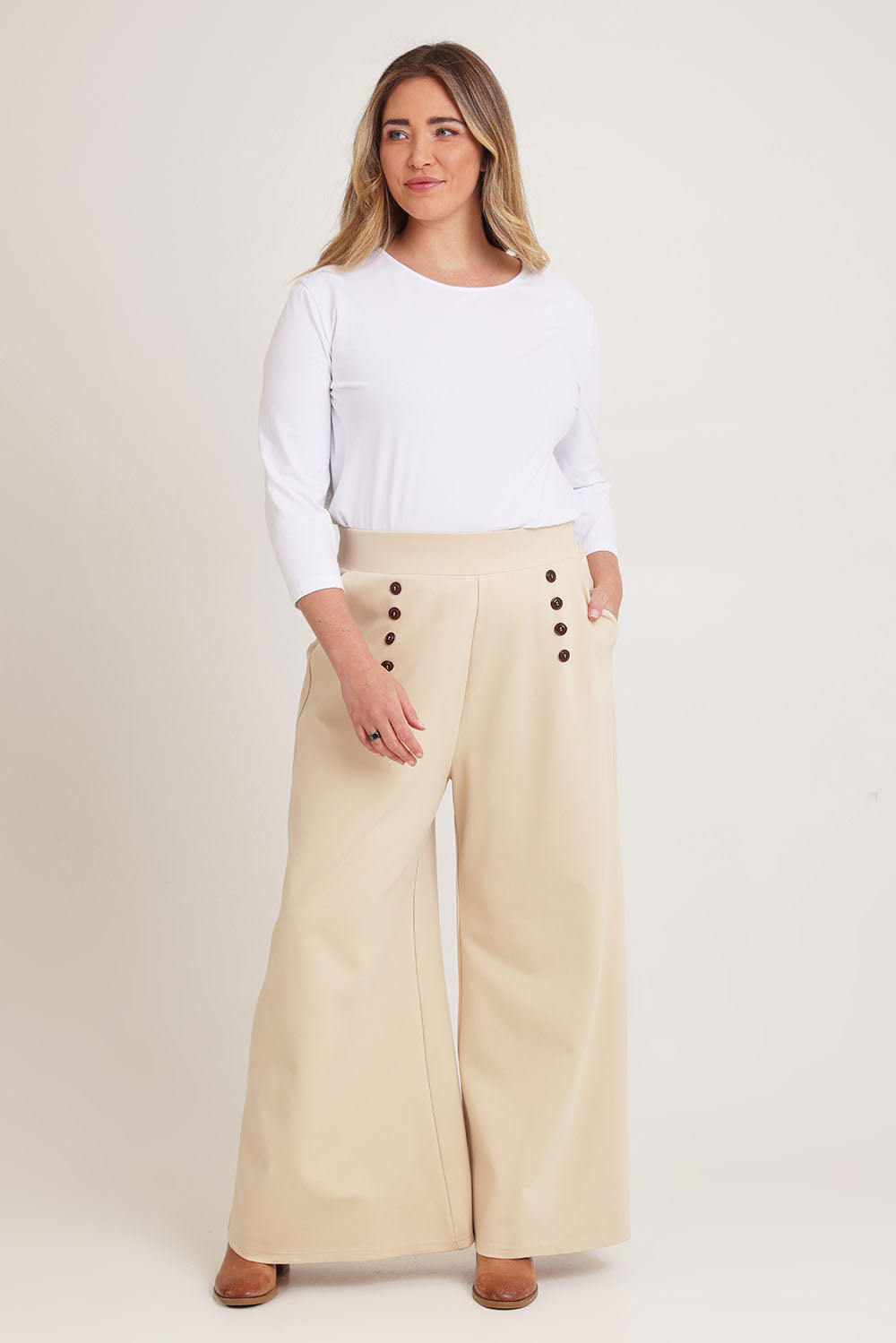 Model Chanel wearing size 16 of the Meet Me At Midnight Wide Leg Ponte Pants in colour Sand, from the front, showing the whole outfit