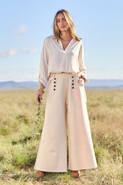 Model Tegan wearing size 10 of the Meet Me At Midnight Wide Leg Ponte Pants in colour Sand, from the front, showing the whole outfit
