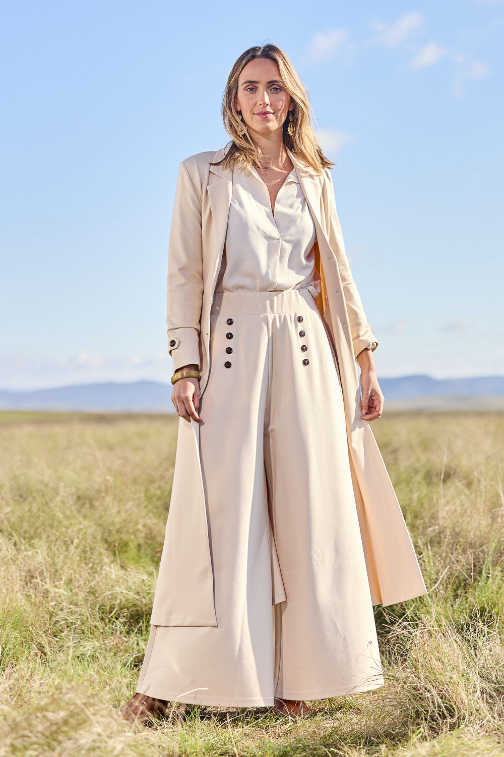 Model Tegan wearing size 10 of the Meet Me At Midnight Wide Leg Ponte Pants in colour Sand, from the front, showing the whole outfit