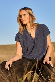 Model Tegan wearing size S of the Found My Friend Recycled Knit Sleeveless Cardi in colour Denim (Blue), from the front, showing the whole outfit