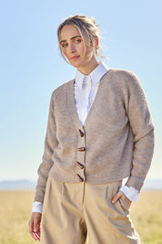 Model Tegan wearing size S of the Found My Friend Recycled Knit Cardi in colour Earth, from the front, showing the whole outfit