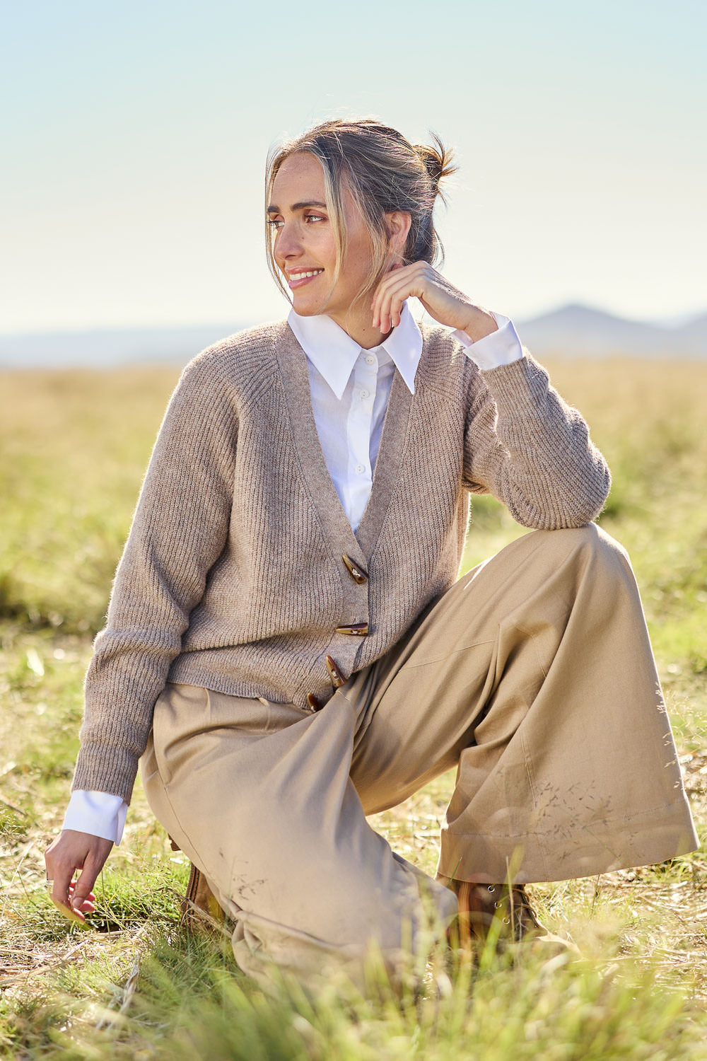 Model Tegan wearing size S of the Found My Friend Recycled Knit Cardi in colour Earth, from the front, showing the whole outfit