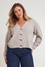 Model Chanel wearing size XL of the Found My Friend Recycled Knit Cardi in colour Oatmeal, from the front, cropped image