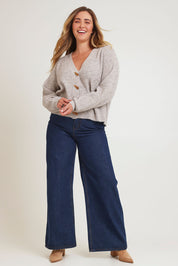 Model Chanel wearing size XL of the Found My Friend Recycled Knit Cardi in colour Oatmeal, from the front, showing the whole outfit