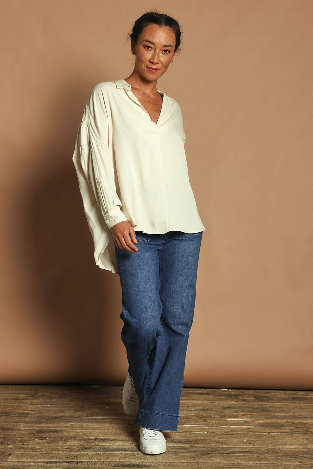 Model Katie wearing size 10 of the Easy Does It Popover Shirt in colour Latte, from the front, showing the whole outfit