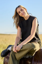 Model Tegan wearing size S of the Found My Friend Recycled Knit Vest in colour Black (Black), from the front, showing the whole outfit