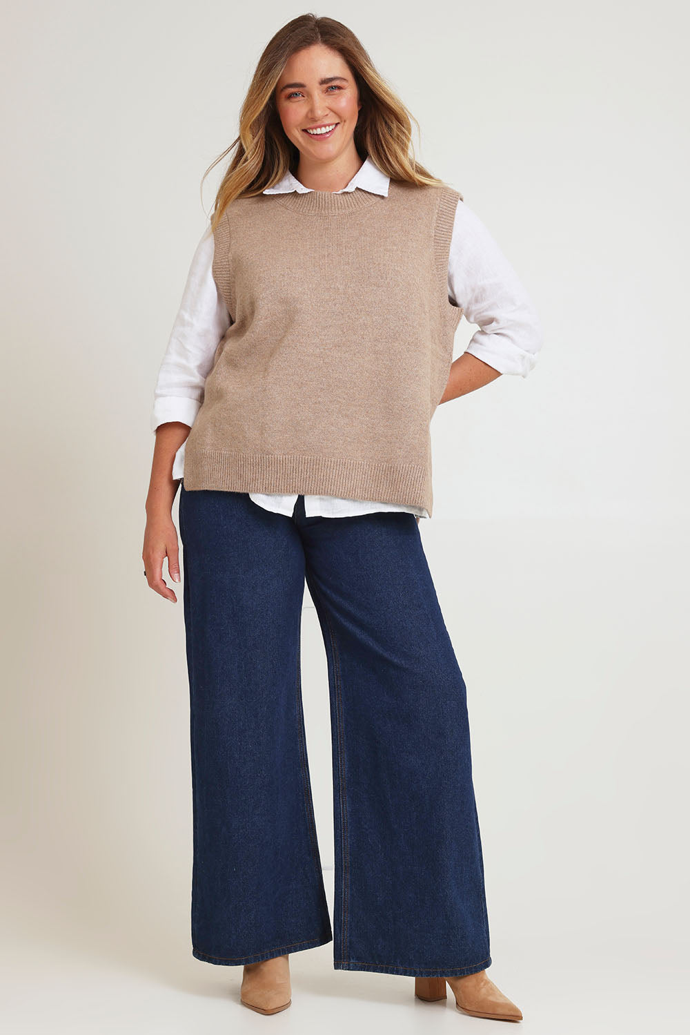 Model Chanel wearing size XL of the Found My Friend Recycled Knit Vest in colour Fawn, from the front, showing the whole outfit