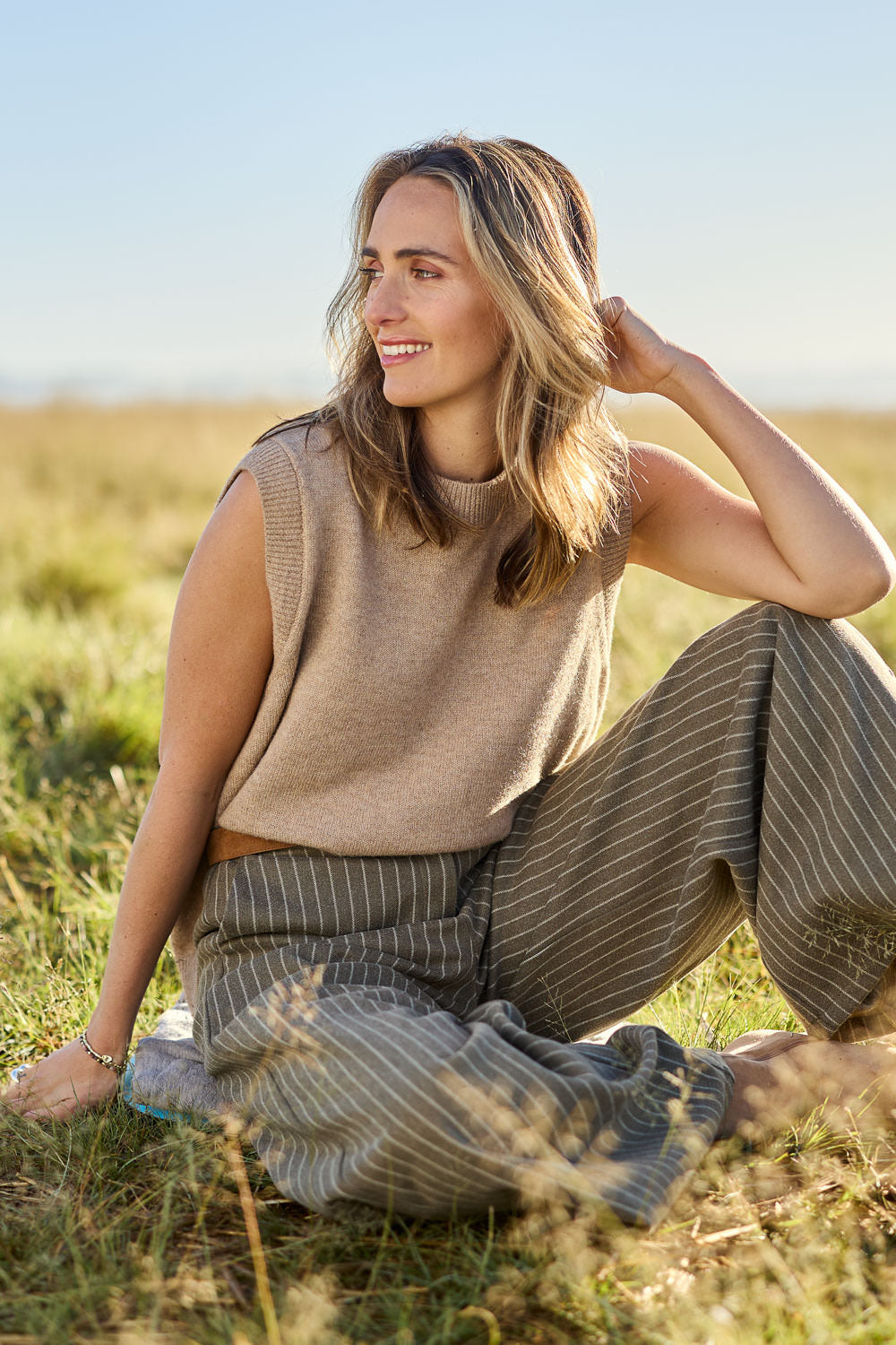 Model Tegan wearing size S of the Found My Friend Recycled Knit Vest in colour Fawn, from the front, showing the whole outfit