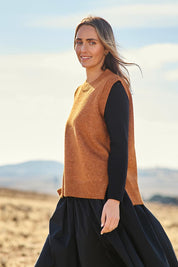 Model Tegan wearing size S of the Found My Friend Recycled Knit Vest in colour Ochre, from the front, showing the whole outfit